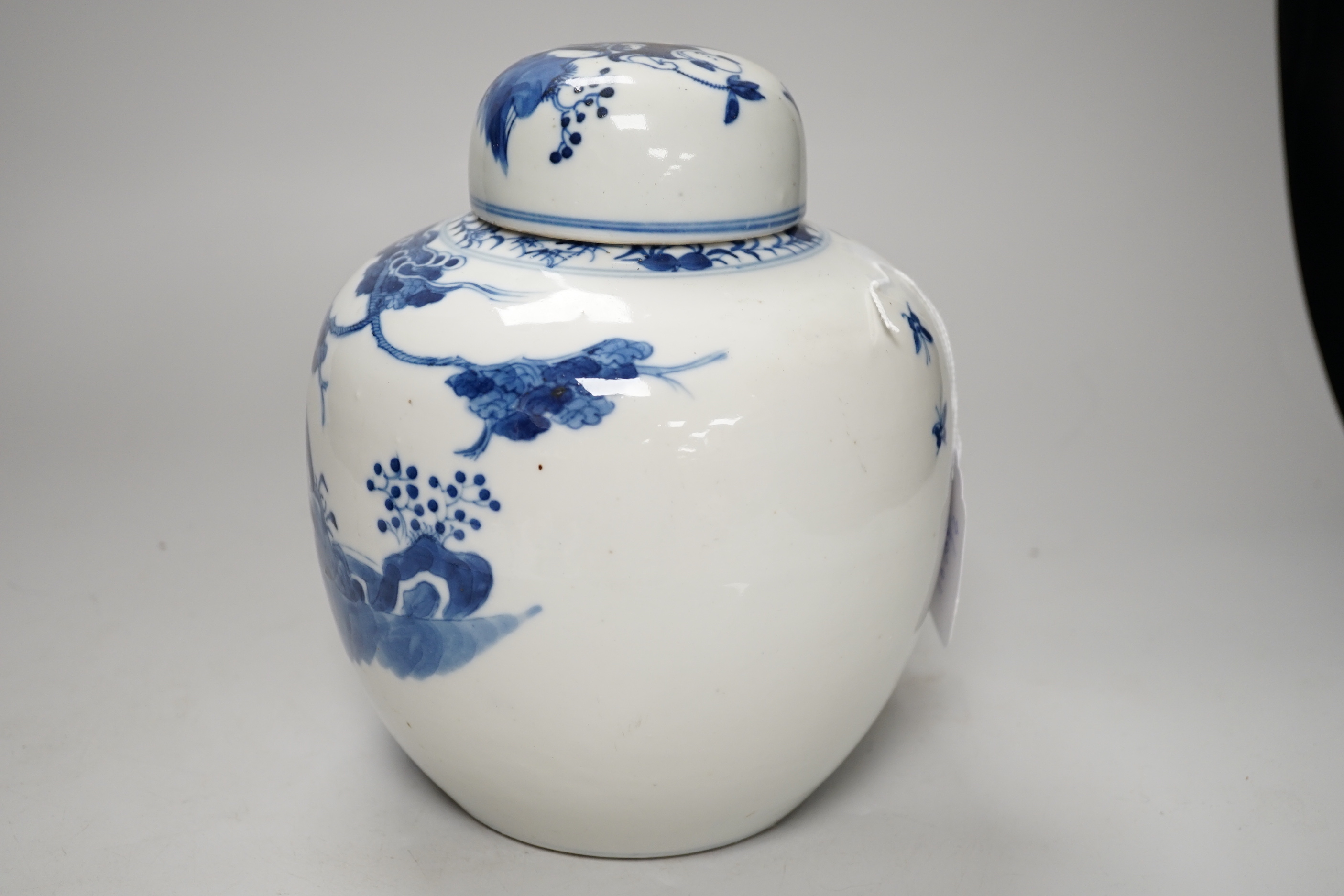 A 19th century Chinese blue and white jar and cover, hand painted with figures in a landscape, 20cm high
